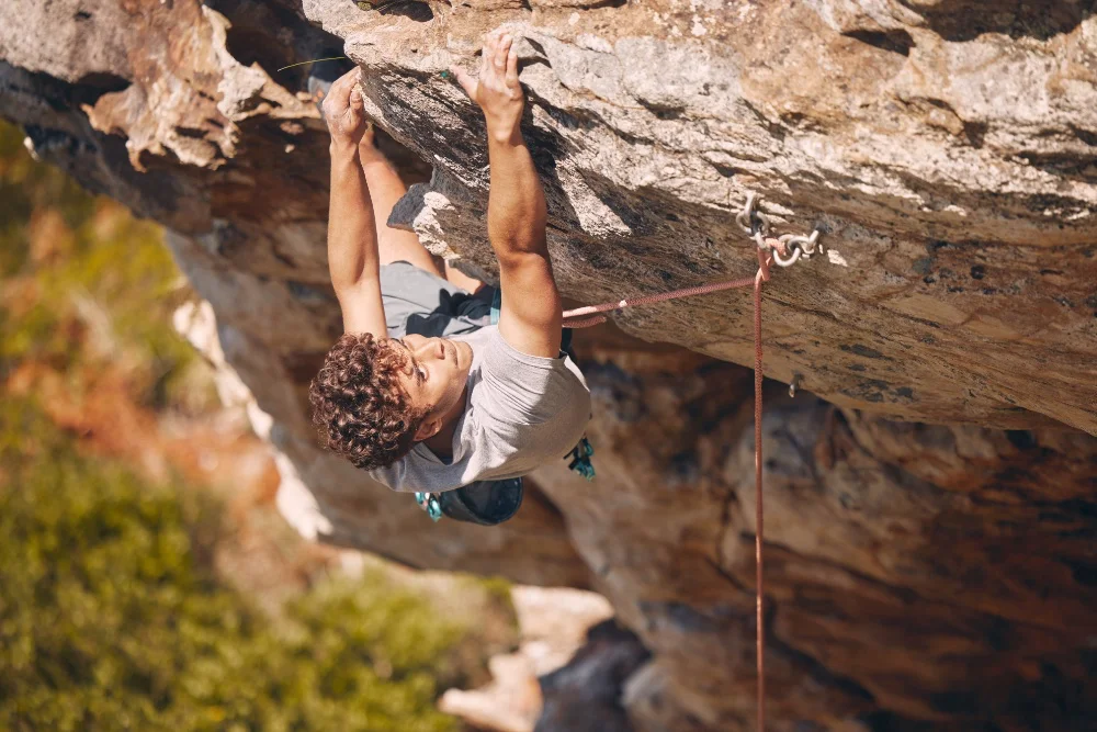 man rock climbing about to fall