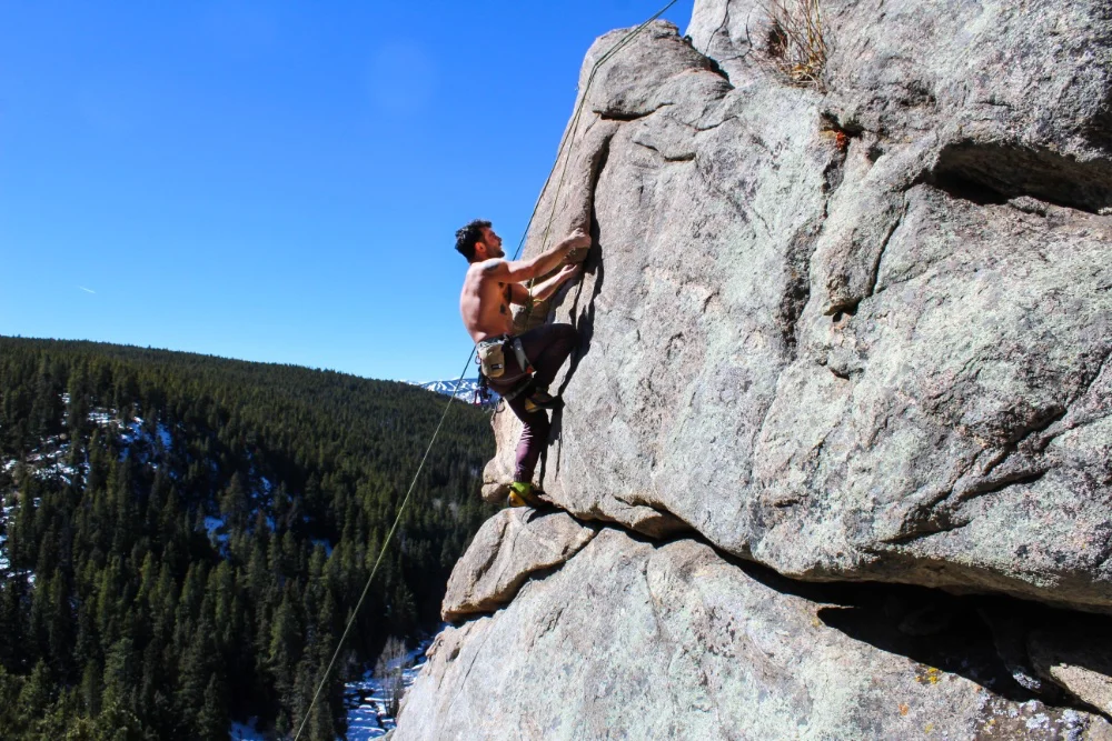 man pitch climbing in sunlight