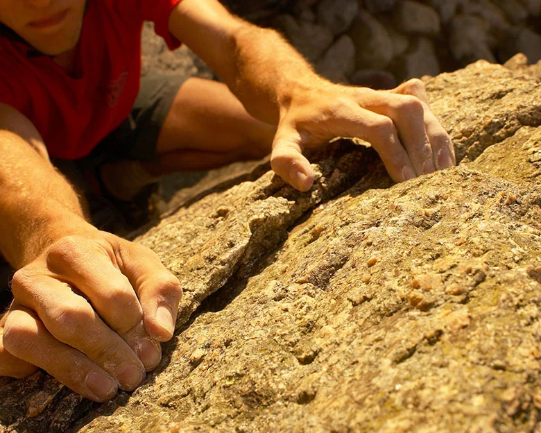 What are the environmental and ethical considerations of free climbing and free soloing on natural rock formations